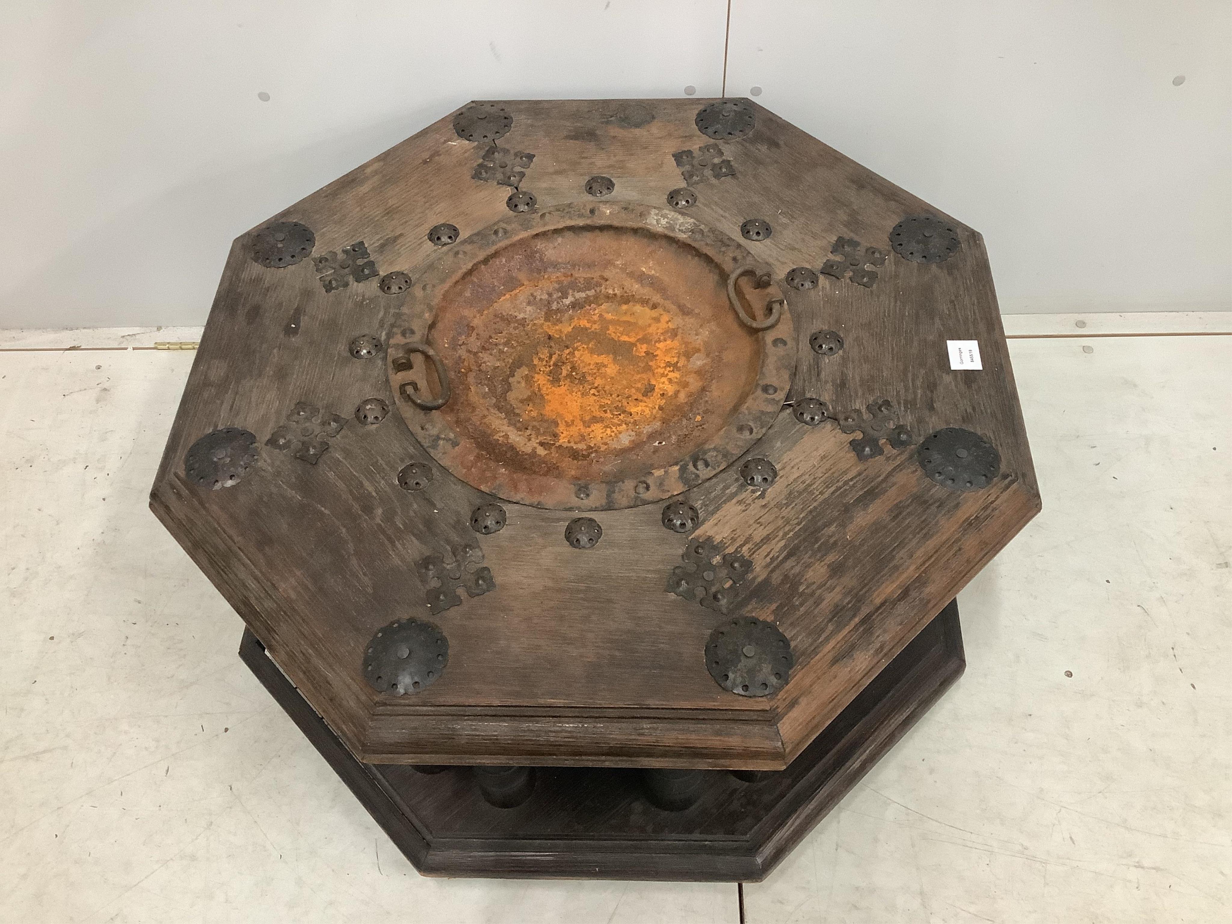 An Indian iron mounted octagonal hardwood brazier table, width 92cm, height 48cm. Condition - poor